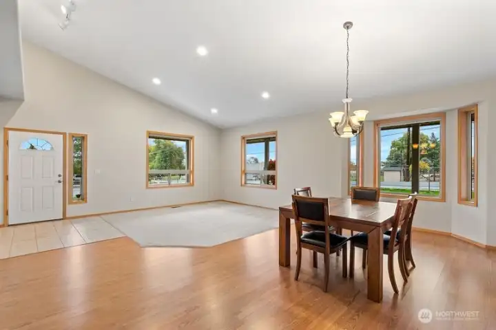 Large living room and dining room area with views out every window.