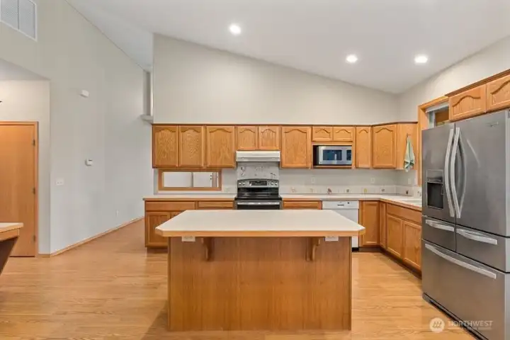 Spacious kitchen with large island and space for at least 3 island stools. Tons of cabinetry for storing all your pots, pans and dishes!