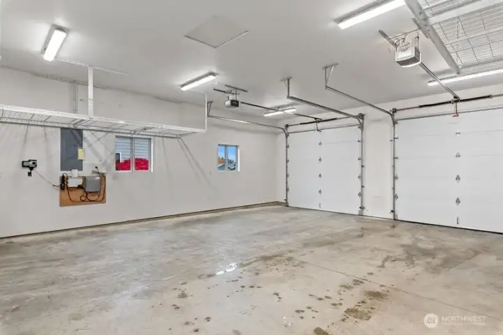 Oversized 2 car garage, storage racks and work shelving stay with home. Automatic garage door openers. This home has it all!