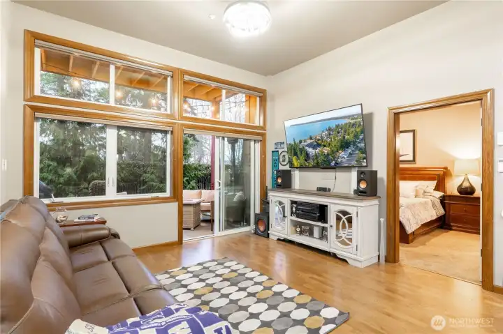 Living room with patio slider door entry and also primary bedroom.