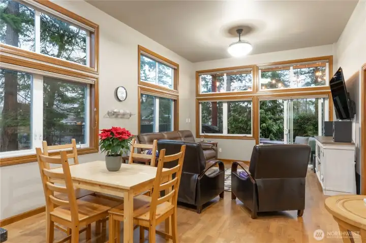 Dining room with living room in the background.over head light fixture has two settings, brightest shown here.