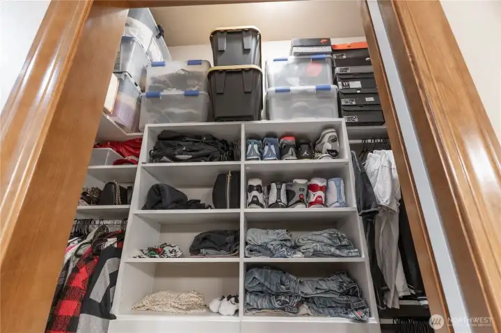 Both bedroom closets have custom built-in closets which is a great extra feature! Note the white pocket door to the right which can shut off any view of the closet in the primary bedrooms shown here.