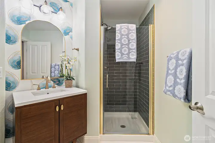 Main floor bath with custom tile shower surround.