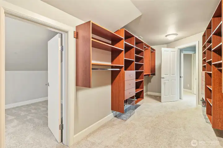 The primary closet continues through door on the left.