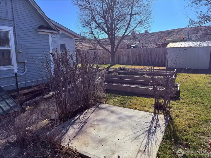 Raised beds and access to the basement behind the house