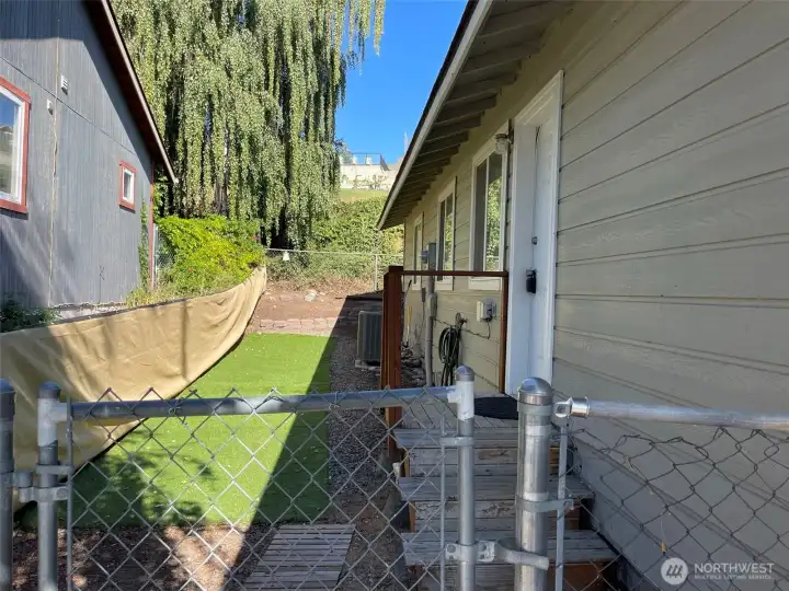Unit A side yard includes low-maintenance turf and a fence for added privacy.