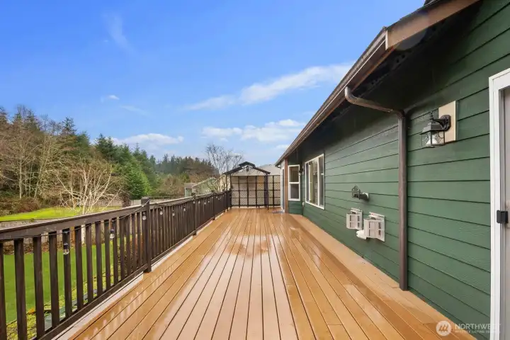 Extended deck area with railing and lighting, offering ample space for outdoor seating and entertaining.