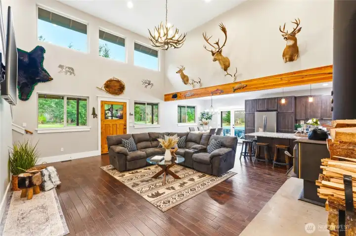 The open floorplan connects the main living areas seamlessly while ushering in abundant natural light through  nature-filled picture windows.