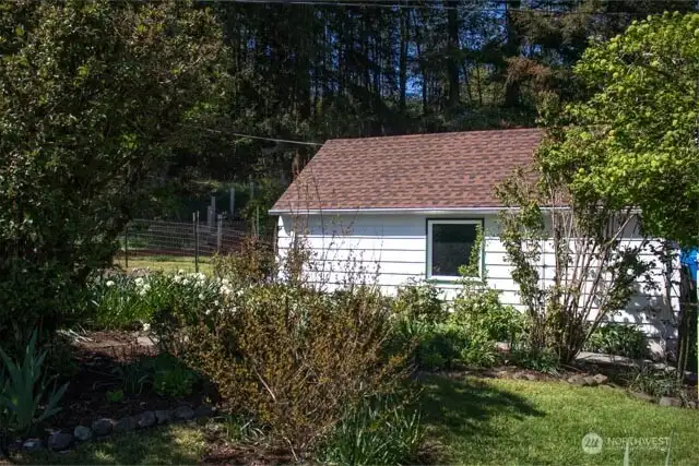 South side of garage, next to pathway