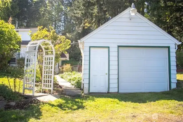 Front view from street, garage and archway to home