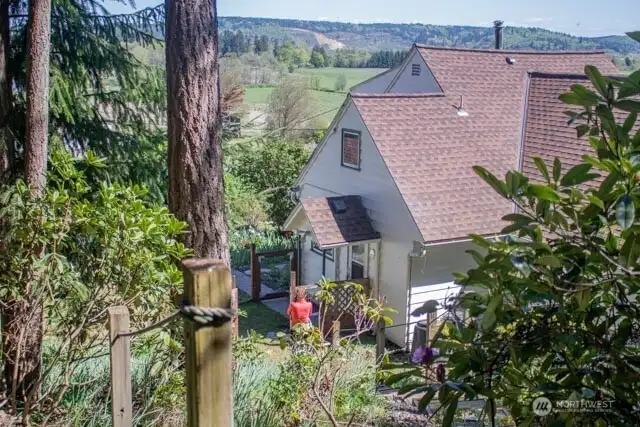 North West View of home, roofline and trees