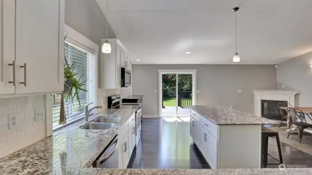 Big and bright open kitchen with white cabinets and modern cabinet pulls.