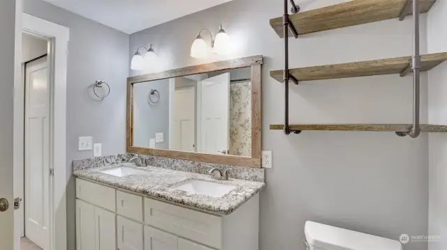 Full primary bathroom with dual sinks and great storage.