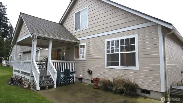 The back of the home looking at the covered deck and patio.