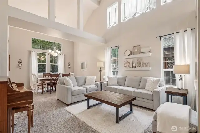 Light and open living and dining room off entry with vaulted ceilings.