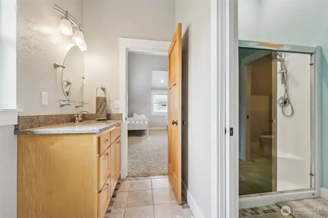 The second bedroom is attached to a private bathroom that shares a shower room with the adjacent room.
