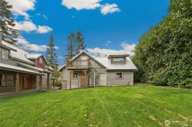 The house and detached 3-car garage with upstairs loft apartment is situated on a beautiful high bank waterfront lot.