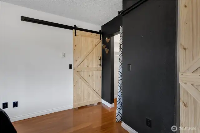 Barn doors add a touch of class in the Primary Bedroom