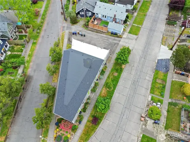 New Roof in 2025!  Notice the parking lot behind the building which is available for unit owners/guests to use.