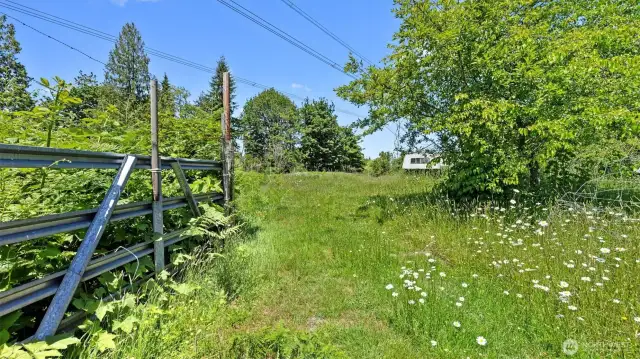 This gate leads to a very large fenced garden space.