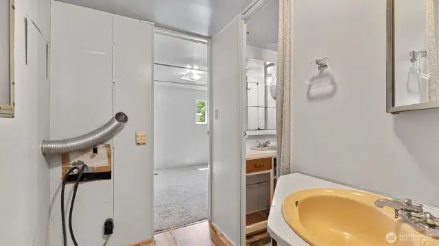 Space for a stackable washer and dryer on the left side at the end of the hall.