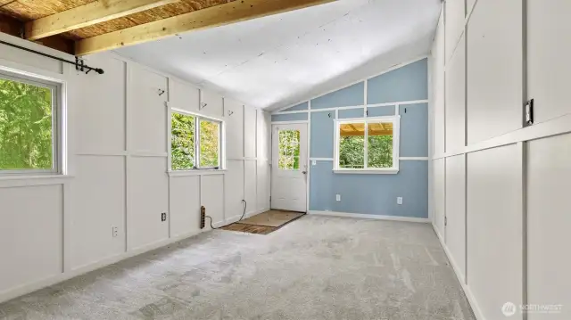 Living room with a door that leads to the backyard.