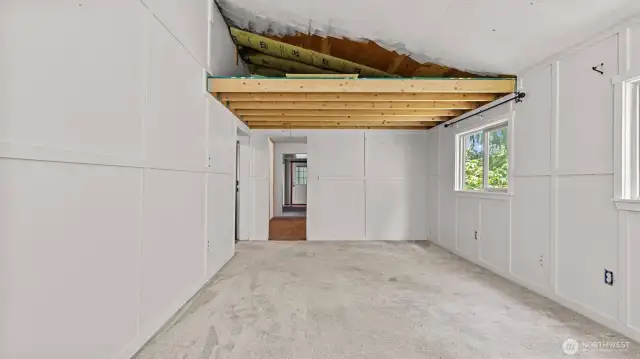 One more view of the living room and unfinished space for storage above.
