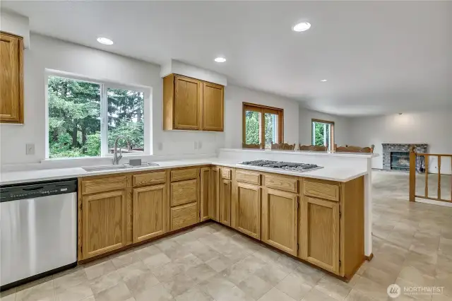 The kitchen offers wonderful views of the backyard and greenery beyond.