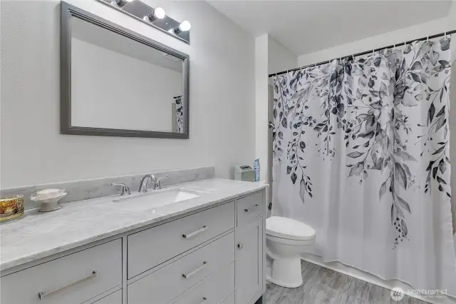 The upstairs hall bath is also updated.