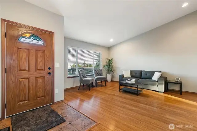 Spacious living room with vaulted ceiling as you enter the home