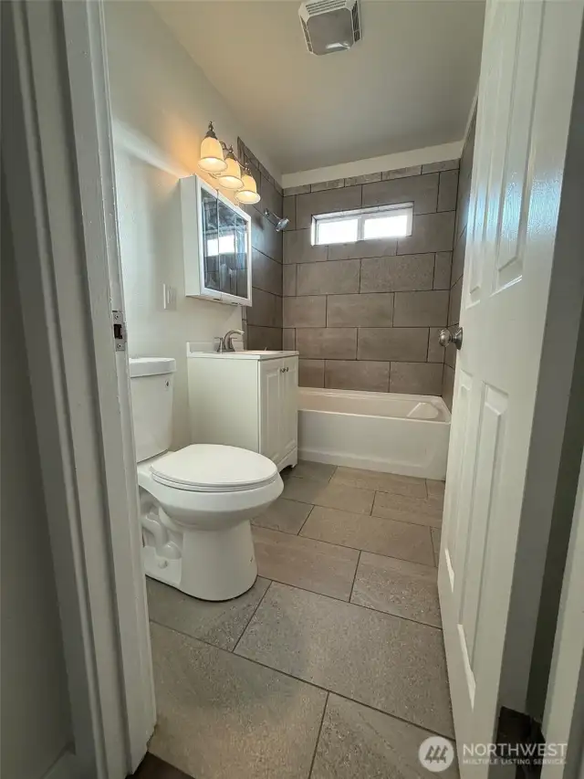 This bathroom really impresses with its blend of new tiling