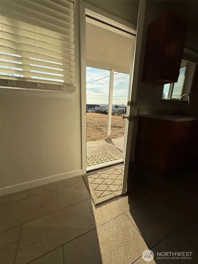 This kitchen and dining room door leads out to the backyard covered patio for outside dining and city views