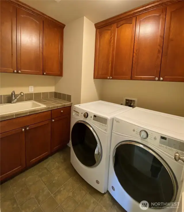 Laundry Room equipped with sink and plenty of storage!