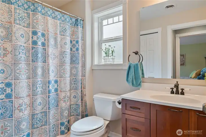 Hallway full Bathroom upstairs with it's own window and storage Closet (as seen in the mirror)