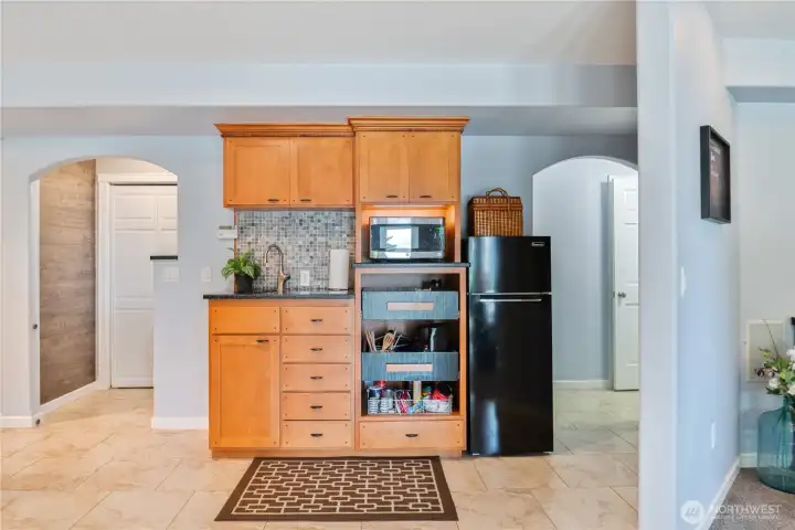 Those same stairs are behind the arch on the left, and some extra Storage plus a Bathroom is behind the arch to the right.  (Living area jaunts off to the right of the partial wall ....)