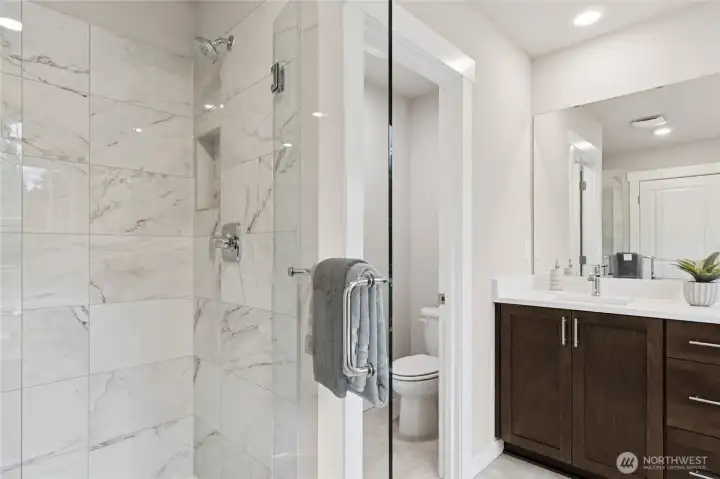 Large walk-in shower with full glass enclosure. Primary bedroom with 5-piece attached bathroom and walk-in closet. Materials, colors, and finishes will vary. See site agent for details