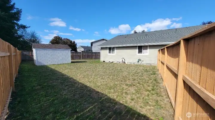 Large back yard of Unit B  with extra storage shed