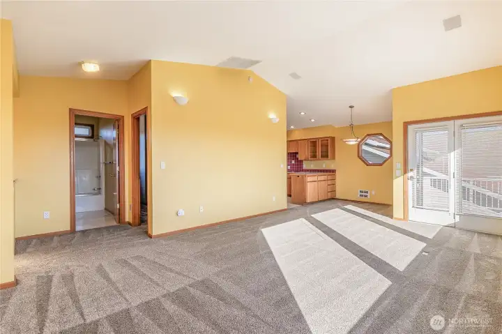 Living area open to kitchen and dining areas.