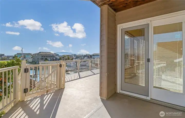 Come out on the deck and enjoy some sunshine and sea breezes.  Gate leads to lower patio and the boat dock.