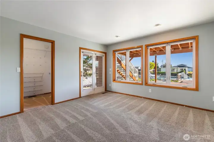 Primary Suite with walk-in closet and private bath with double basins and walk-in shower.