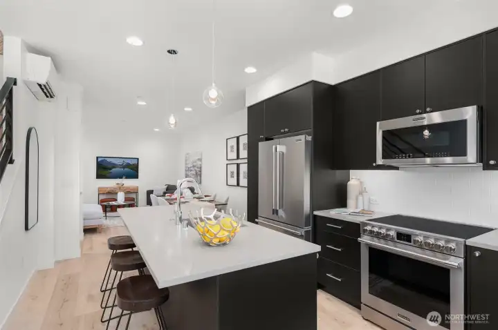 Photos of model home 9213 with similar finishes & floor plan. This kitchen brings serious style and substance from entertaining to everyday meal prep. Bonus: all that natural light!