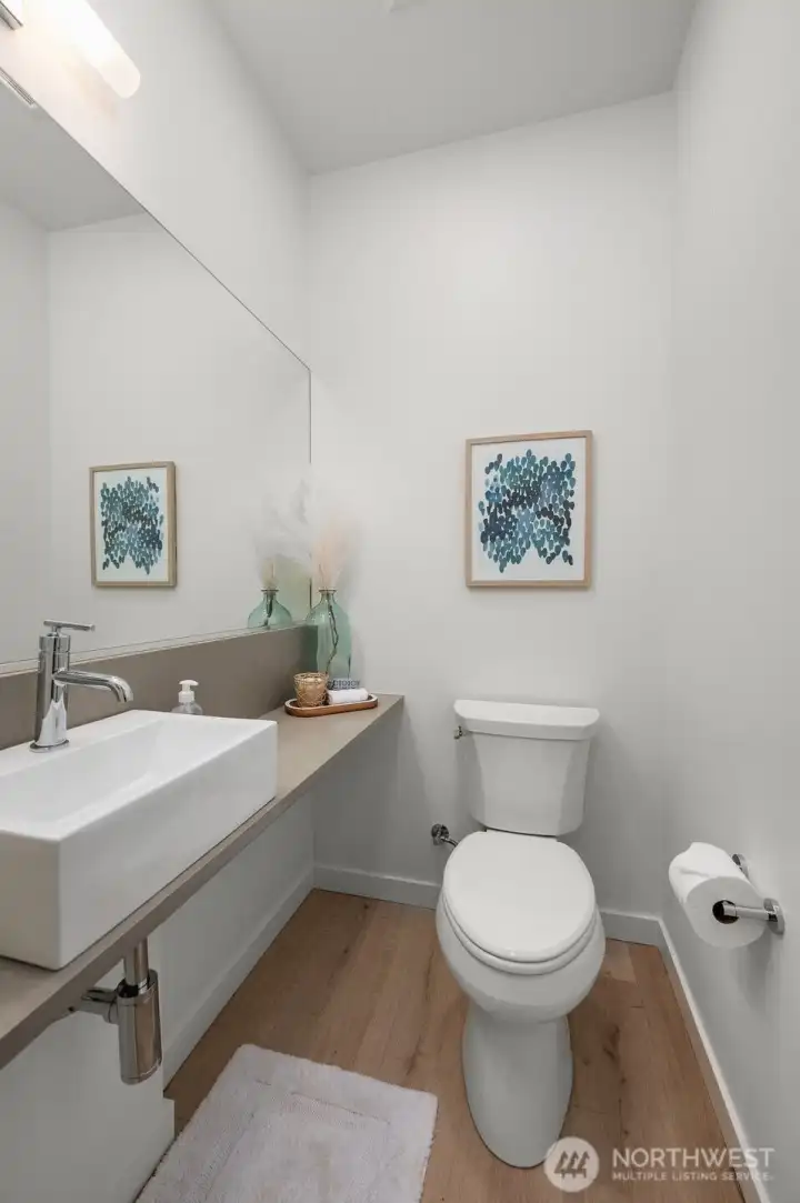 Photos of model home 9213 with similar finishes & floor plan. Even the powder room feels elevated. Modern fixtures, clean design, and just the right pop of personality.