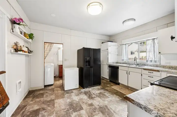 Kitchen leads to the full bath on the main floor as well as washer and dryer space