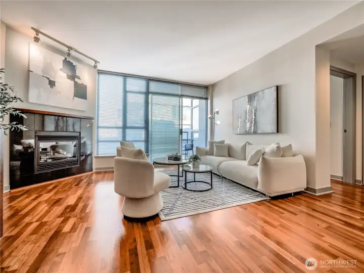 Step inside to sun-drenched interiors and a sleek fireplace that anchors the sophisticated open-concept living space. This is a staged photo