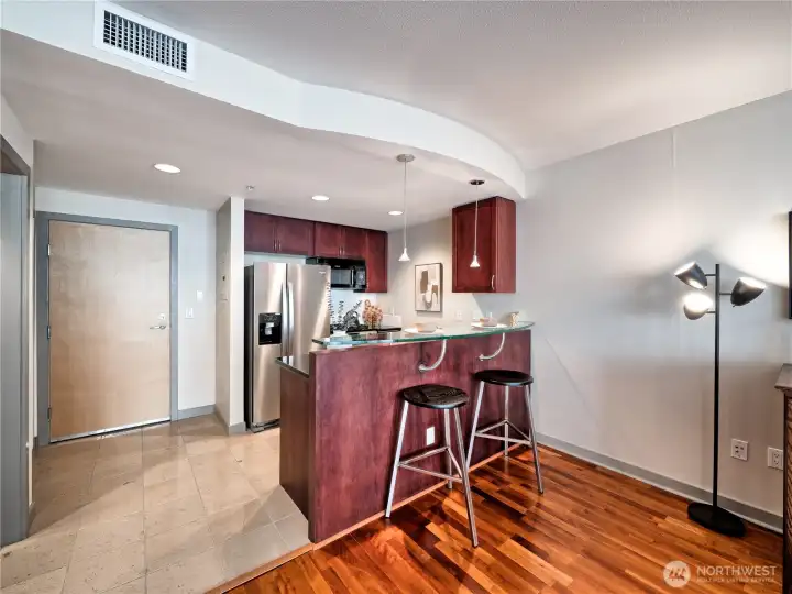 The social-centric kitchen bar serves as your command center, keeping the chef at the absolute heart of the conversation and the home’s internal energy.. This is a staged photo