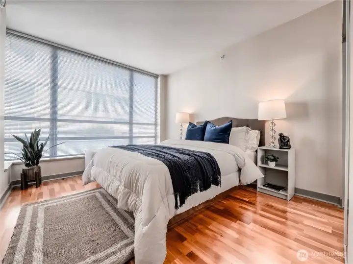 Retreat to a serene bedroom where soft, natural light and modern design invite absolute relaxation. This is a staged photo.