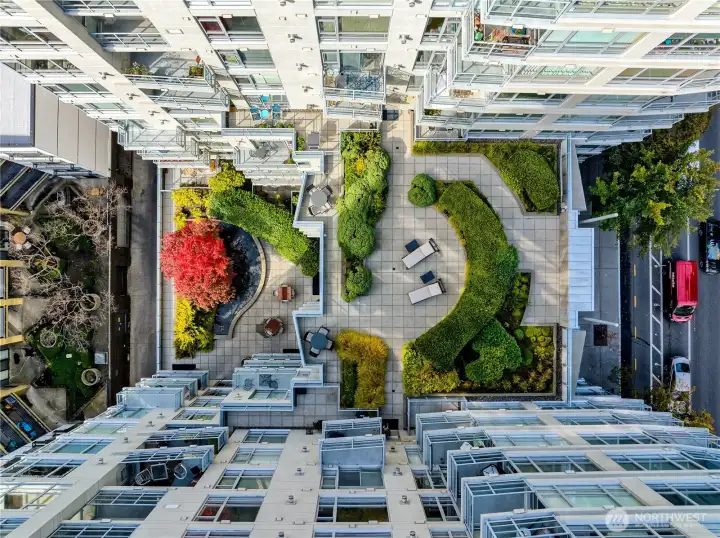 Aerial view of the building's massive, dual-level outdoor amenity terraces.