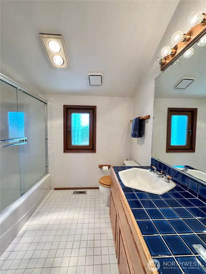 Third story/ guest full bath with lots of light and tile counter!