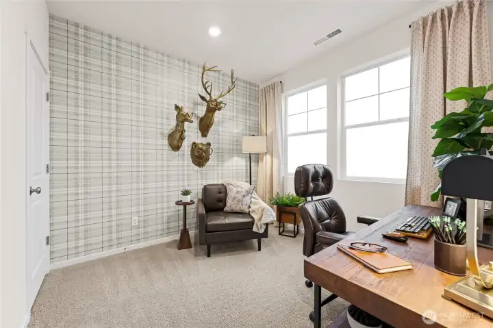 Main floor bedroom perfect as a guest room or home office space. Photo is representational. Actual home is under construction and colors, materials, and finishes may vary. See site agent for details.