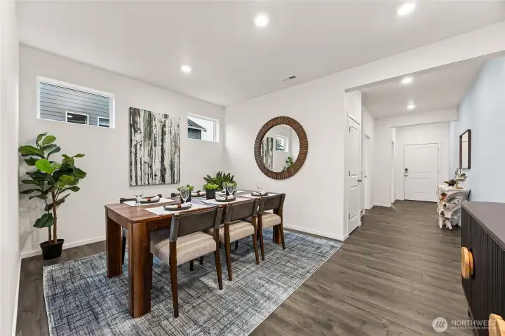 Large dining room for hosting dinner parties. Photo is representational. Actual home is under construction and colors, materials, and finishes may vary. See site agent for details.